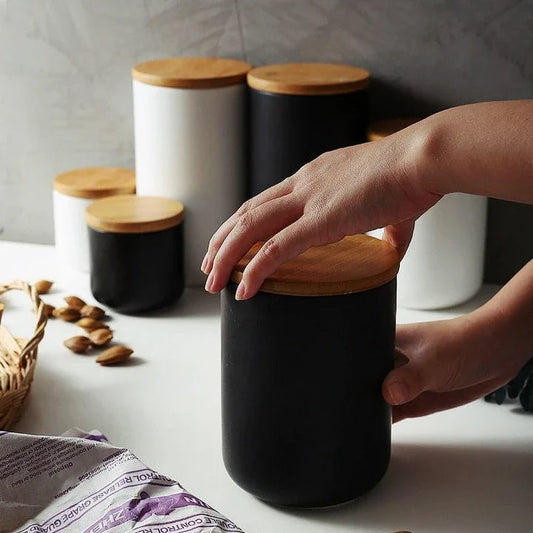 Elegant ceramic storage jars with airtight lids, available in small, medium, and large sizes for versatile kitchen organisation.