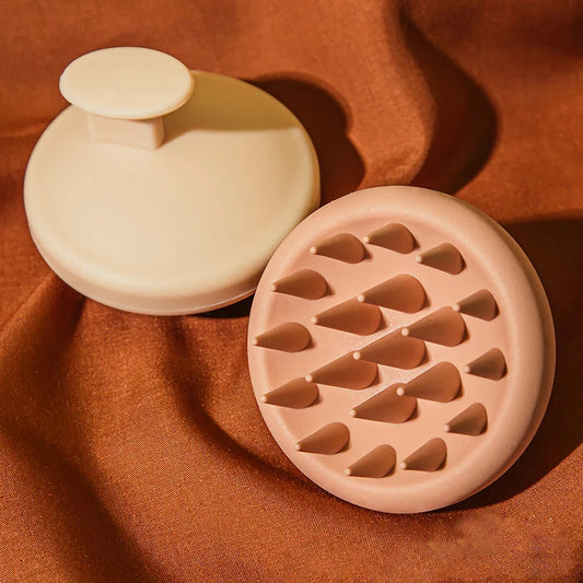 A green silicone scalp massager with soft bristles, designed to provide a soothing hair washing experience and promote healthy hair growth.