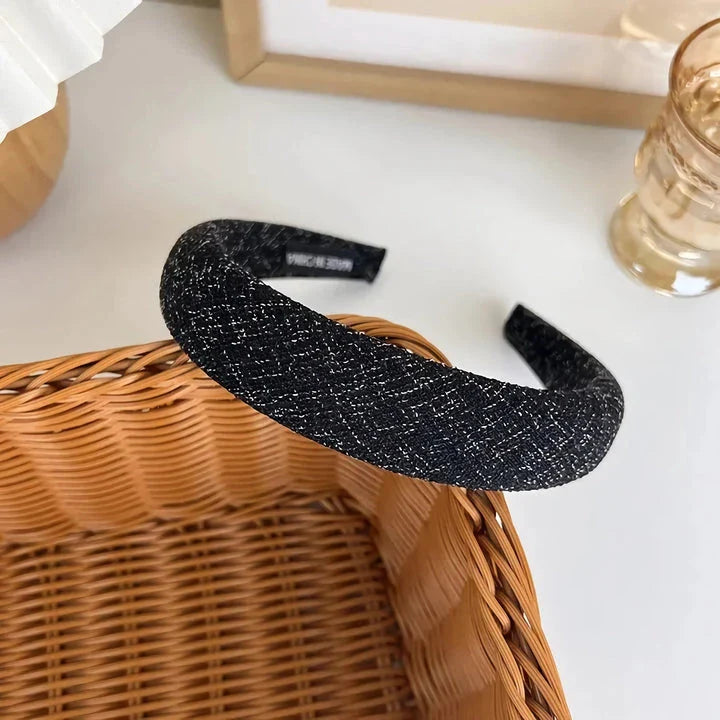 A stylish wide hairband in a classic plaid pattern, offering a chic and sophisticated look for British women.