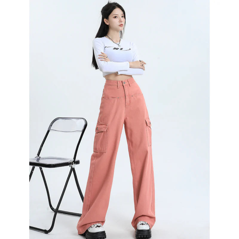A pair of pink high-waist baggy jeans with a straight-leg design, featuring vintage-inspired details like buttons and faux zippers.