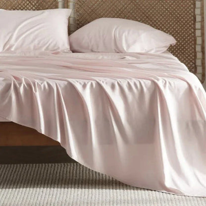 Premium bamboo fibre bed sheets in a classic solid purplish blue colour, featuring a four-piece set including a fitted sheet, flat sheet, and two pillowcases.