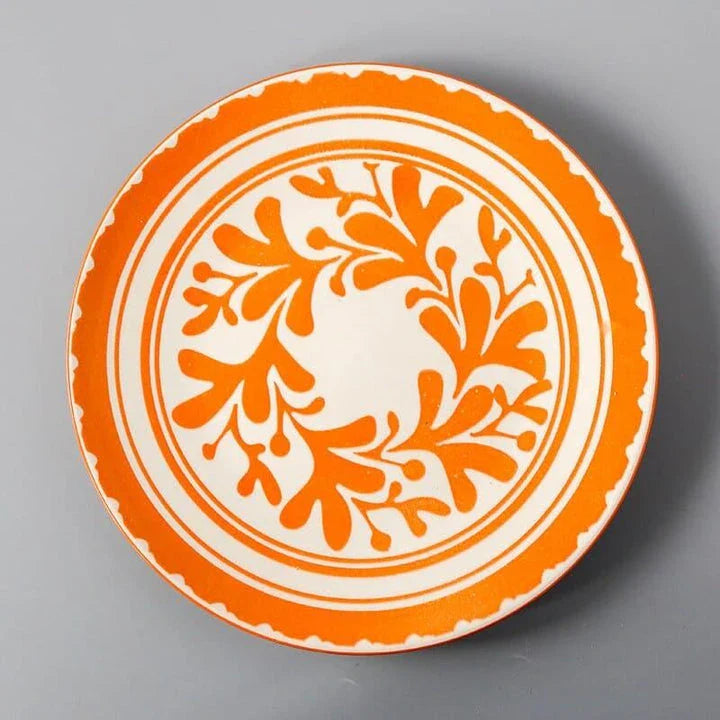 Elegant ceramic plates with vibrant, whimsical prints in a variety of enchanting designs