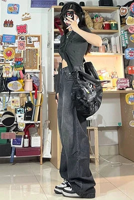 Women's high-waist, wide-leg black denim jeans with multiple pockets and vintage-inspired wash