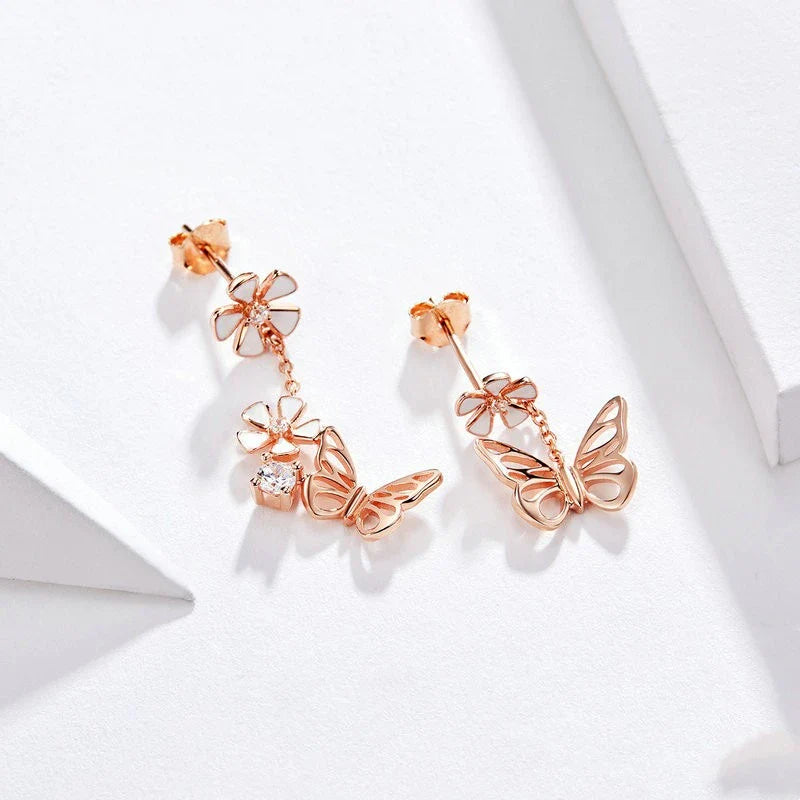 Pair of silver earrings featuring a butterfly-shaped floral design with sparkling white crystals, inspired by the enchanting Forest Series