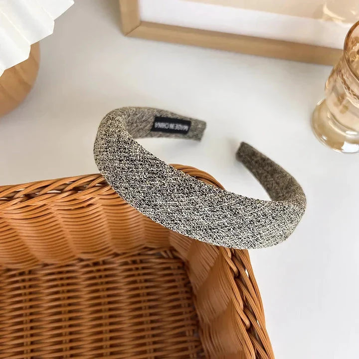 A stylish wide hairband in a classic plaid pattern, offering a chic and sophisticated look for British women.