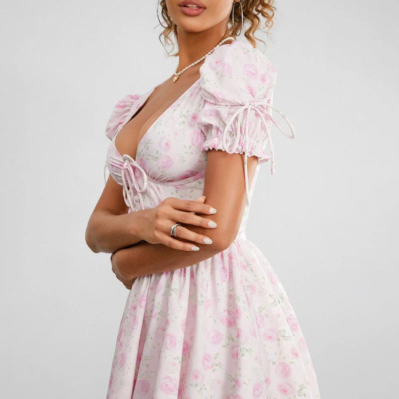 Floral mini dress with puff sleeves, featuring a V-neck, backless design, and A-line silhouette in a vibrant floral print