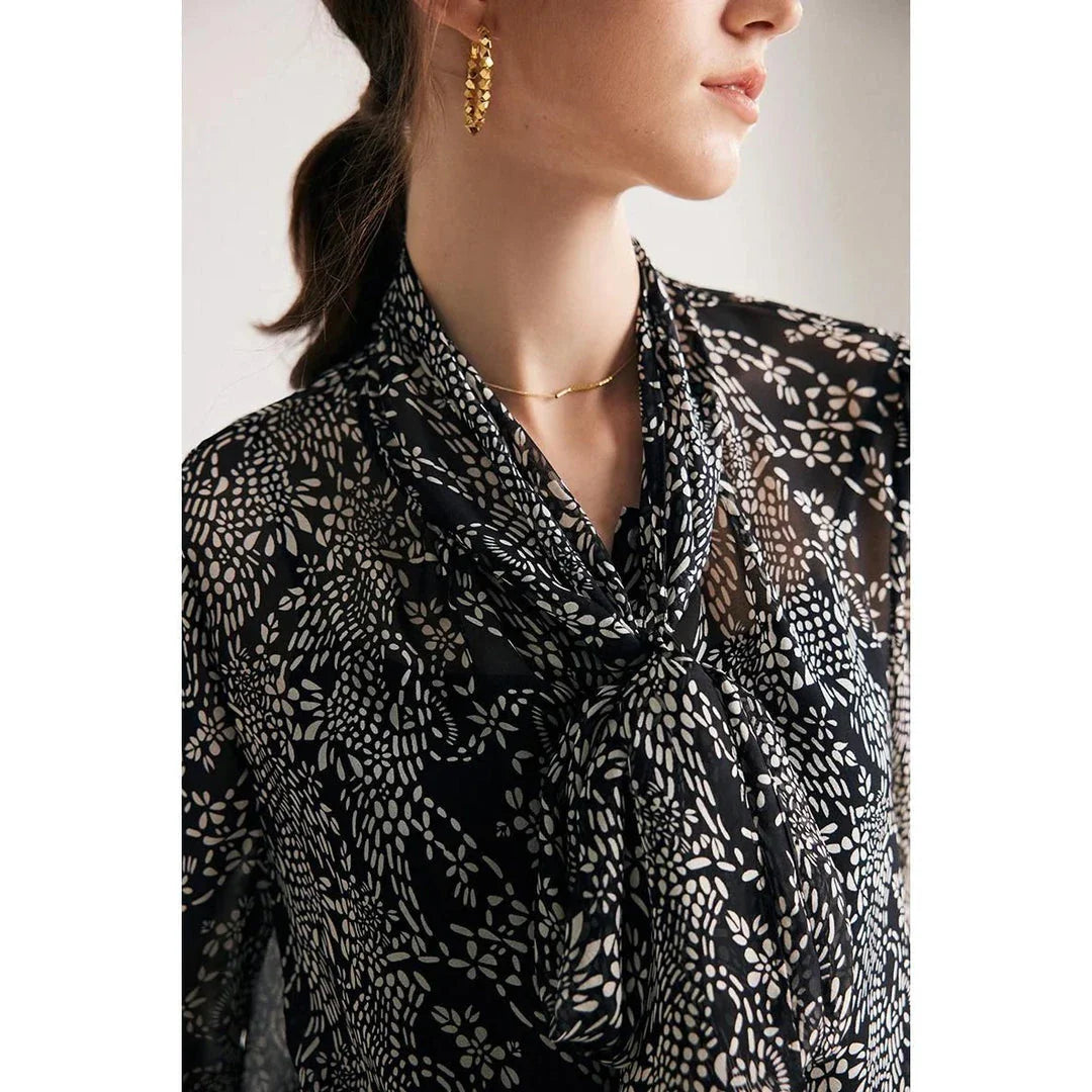 Elegant black silk blouse with unique bow collar, designed for a flattering fit and all-day comfort.
