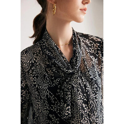Elegant black silk blouse with unique bow collar, designed for a flattering fit and all-day comfort.
