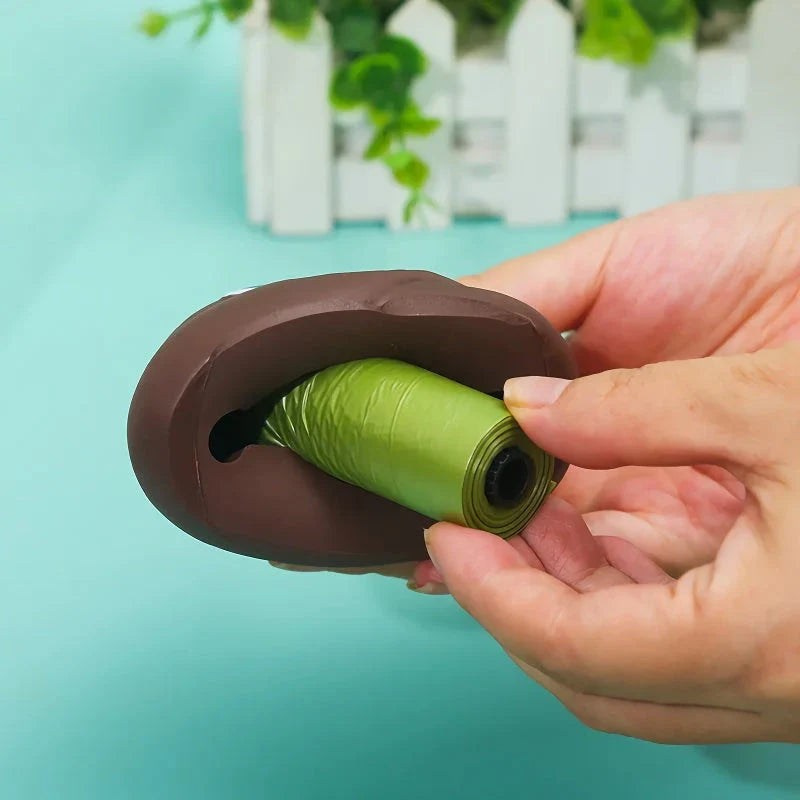 A brown leash-attached poop bag dispenser with a metal carabiner clip, designed for convenient pet waste management during outdoor activities.