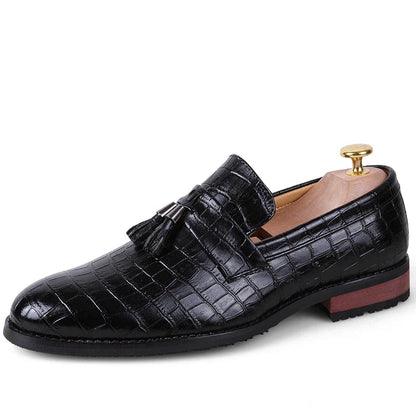 Premium British-crafted men's pointed leather dress shoes with tassels in black color