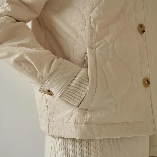 Women's black quilted jacket with button details, perfect for casual winter wear