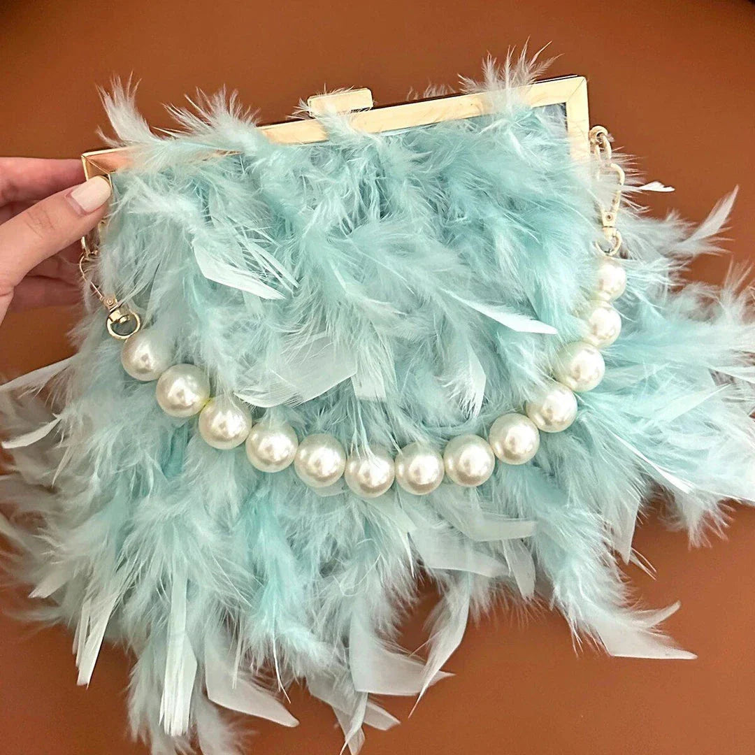 Elegant feather clutch purse with lustrous pearls, metal chains, and a top handle design