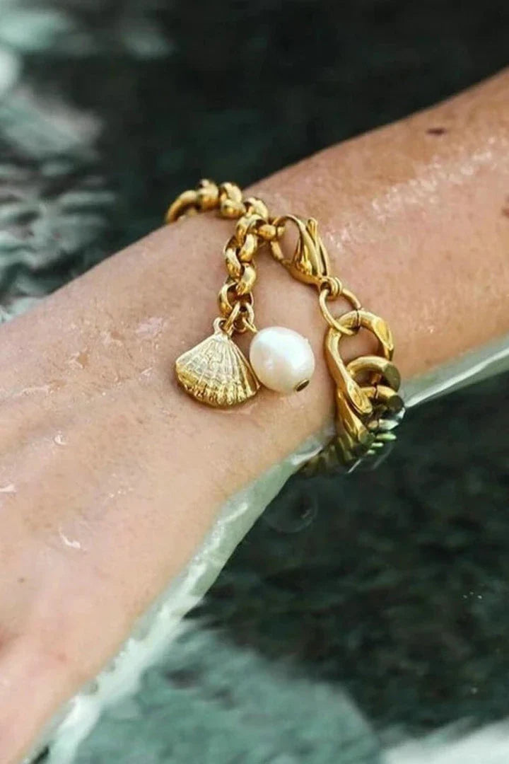 Elegant 18-carat gold-plated curb chain bracelet with a delicate pearl accent, showcasing premium British craftsmanship