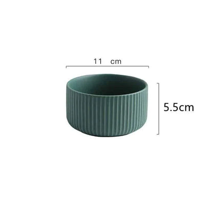 Candy-coloured ribbed ceramic tableware featuring plates, bowls, and other dining accessories in vibrant hues
