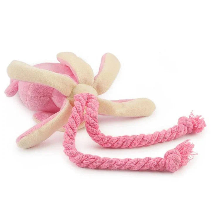 A soft, plush pink squid-shaped dog toy with a vibrant and whimsical design