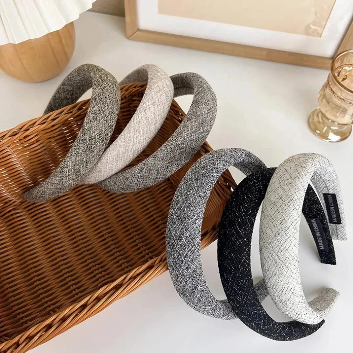 A stylish wide hairband in a classic plaid pattern, offering a chic and sophisticated look for British women.