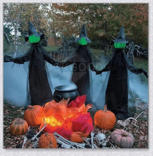 Three tall, black-robed witch figures with faceless glowing heads, standing together and holding hands, creating a spooky outdoor Halloween display
