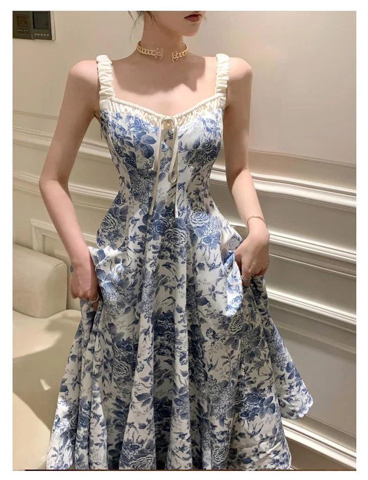 Elegant floral print dress with adjustable straps, A-line silhouette, and high-waisted design for a timeless British fashion look.