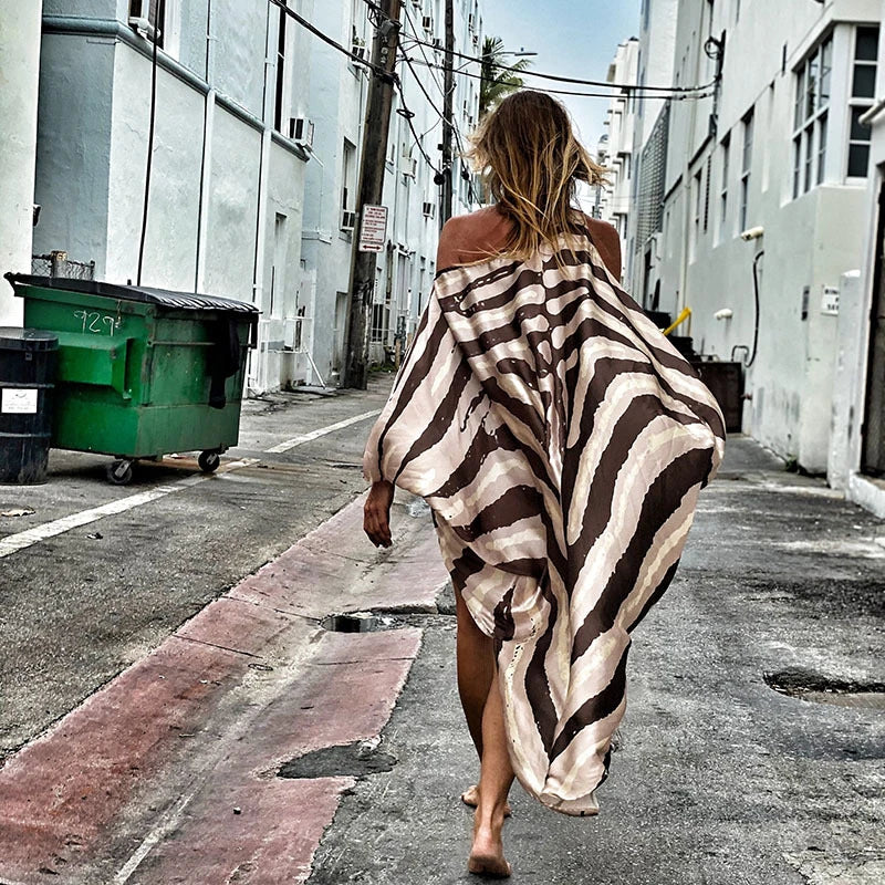 A chic inclined shoulder printed dress in a vibrant colour with a large, swinging skirt