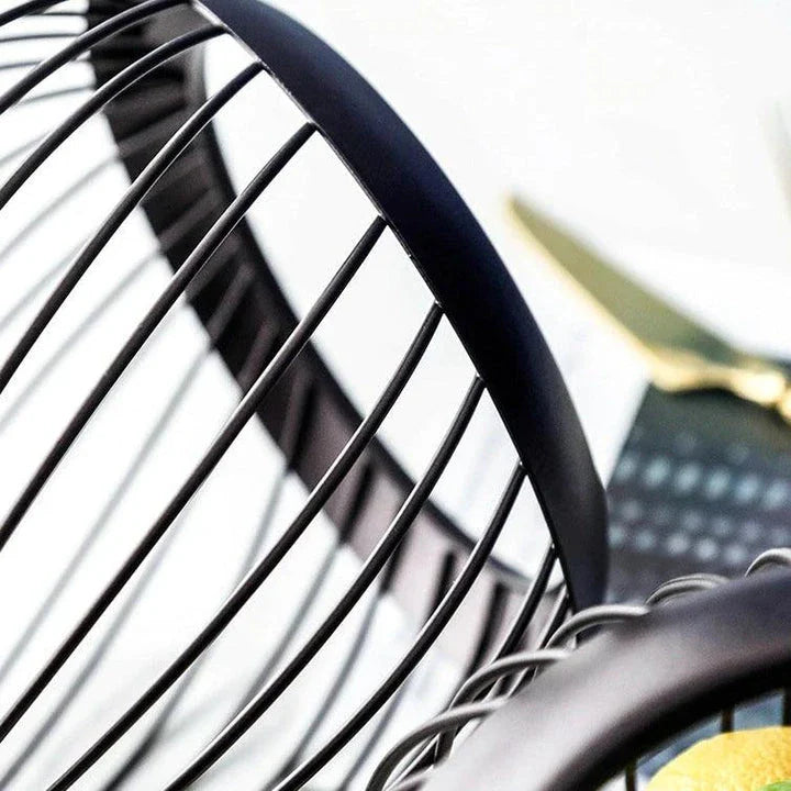 Black Nordic-style metal drain basket with perforated design for efficient drainage