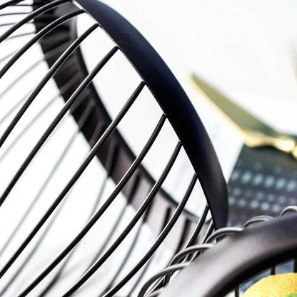 Black Nordic-style metal drain basket with perforated design for efficient drainage