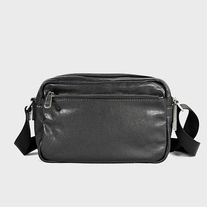 A premium British leather shoulder bag with a sleek, minimalist design and adjustable strap
