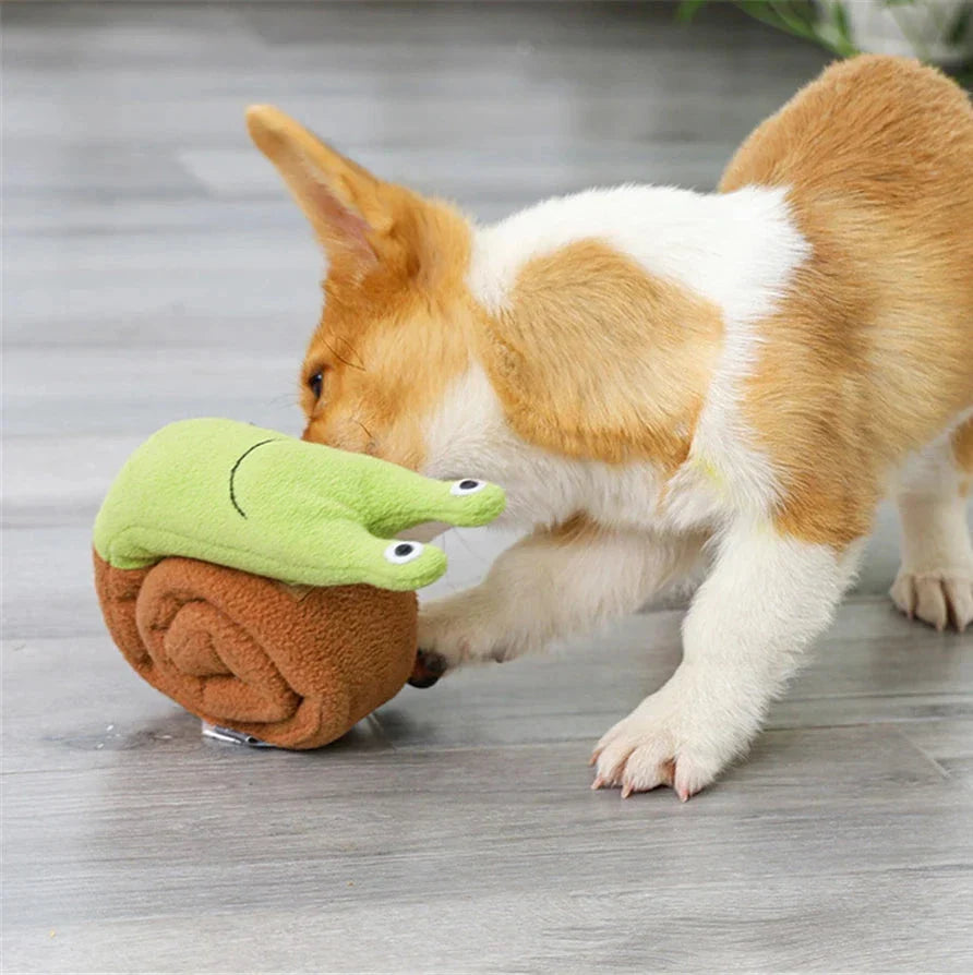 A plush snail-shaped snuffle mat toy with hidden treat pockets, designed to stimulate a dog's natural foraging instincts.