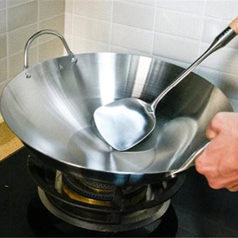 Premium British-made cast iron wok pan with superior heat retention and even heat distribution for versatile cooking