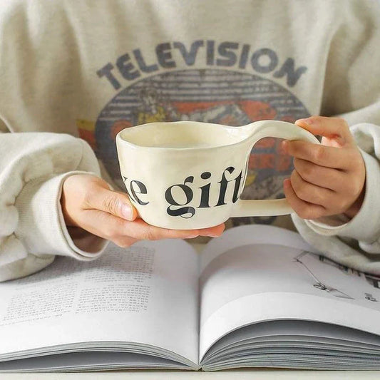 Handcrafted creative alphabet ceramic mug in beige, purple, and khaki colours for hot drinks like coffee and tea