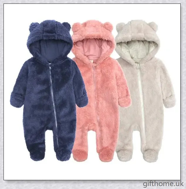 Adorable baby wearing a cosy hooded jumpsuit in blue, pink, or apricot colour