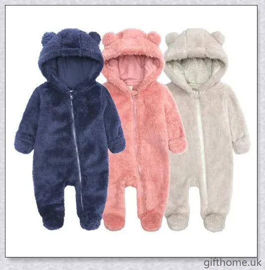 Adorable baby wearing a cosy hooded jumpsuit in blue, pink, or apricot colour