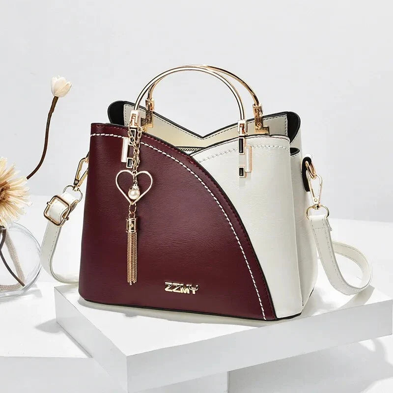 Sophisticated navy blue PU leather bucket crossbody bag with elegant patchwork design and adjustable strap