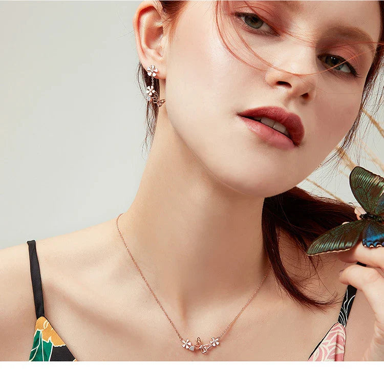 Pair of silver earrings featuring a butterfly-shaped floral design with sparkling white crystals, inspired by the enchanting Forest Series