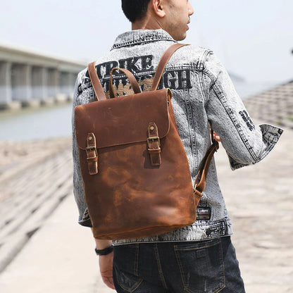 Premium vintage leather backpack with a classic design, featuring a spacious main compartment and adjustable padded shoulder straps for comfortable wear.
