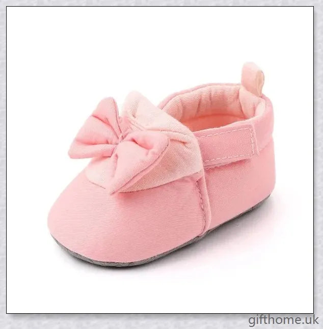 Charming baby toddler shoes with a stylish bowknot design, featuring a breathable cotton upper and non-slip sole for comfort and security.