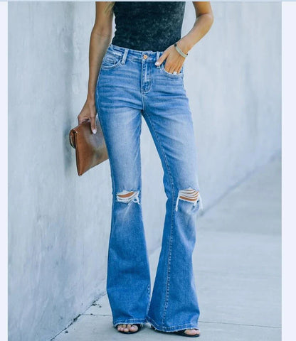 Premium distressed denim trousers for British women, featuring a high-waist silhouette and subtle ripped detailing