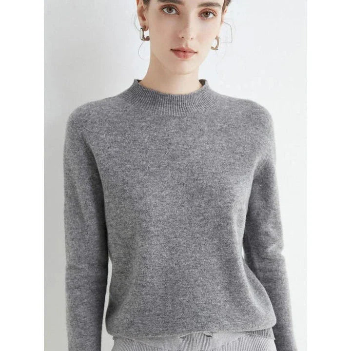 A woman wearing a luxurious Merino wool mock-neck jumper in a stylish autumnal outfit