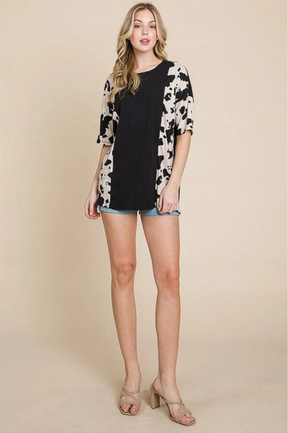 Stylish ribbed tee with playful cow print design, perfect for casual and smart-casual occasions.
