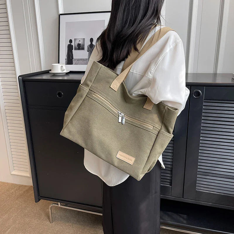 Premium canvas shoulder bag in grey, khaki, and green colours, featuring a stylish and functional design for everyday use.