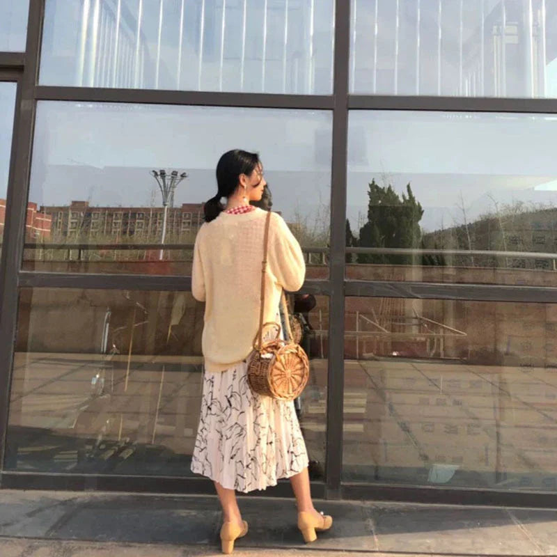 Elegant handcrafted rattan basket handbag with floral design, showcasing traditional British craftsmanship and modern sophistication