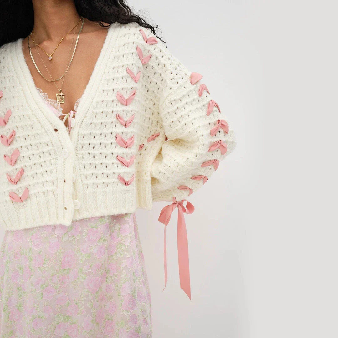 A versatile contrast V-neck tie cardigan in a soft, polyester fabric with a patchwork pattern and lace-up detail for a fashionable and comfortable layering piece.