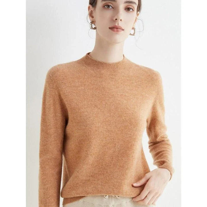A woman wearing a luxurious Merino wool mock-neck jumper in a stylish autumnal outfit