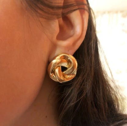 Pair of gold spiral drop earrings with an exaggerated, dramatic design for a bold, fashionable look