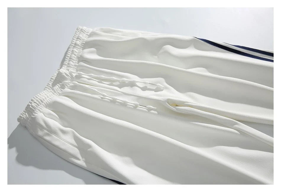 Stylish striped sports trousers in a relaxed, mid-waist design for versatile leisure and athletic wear