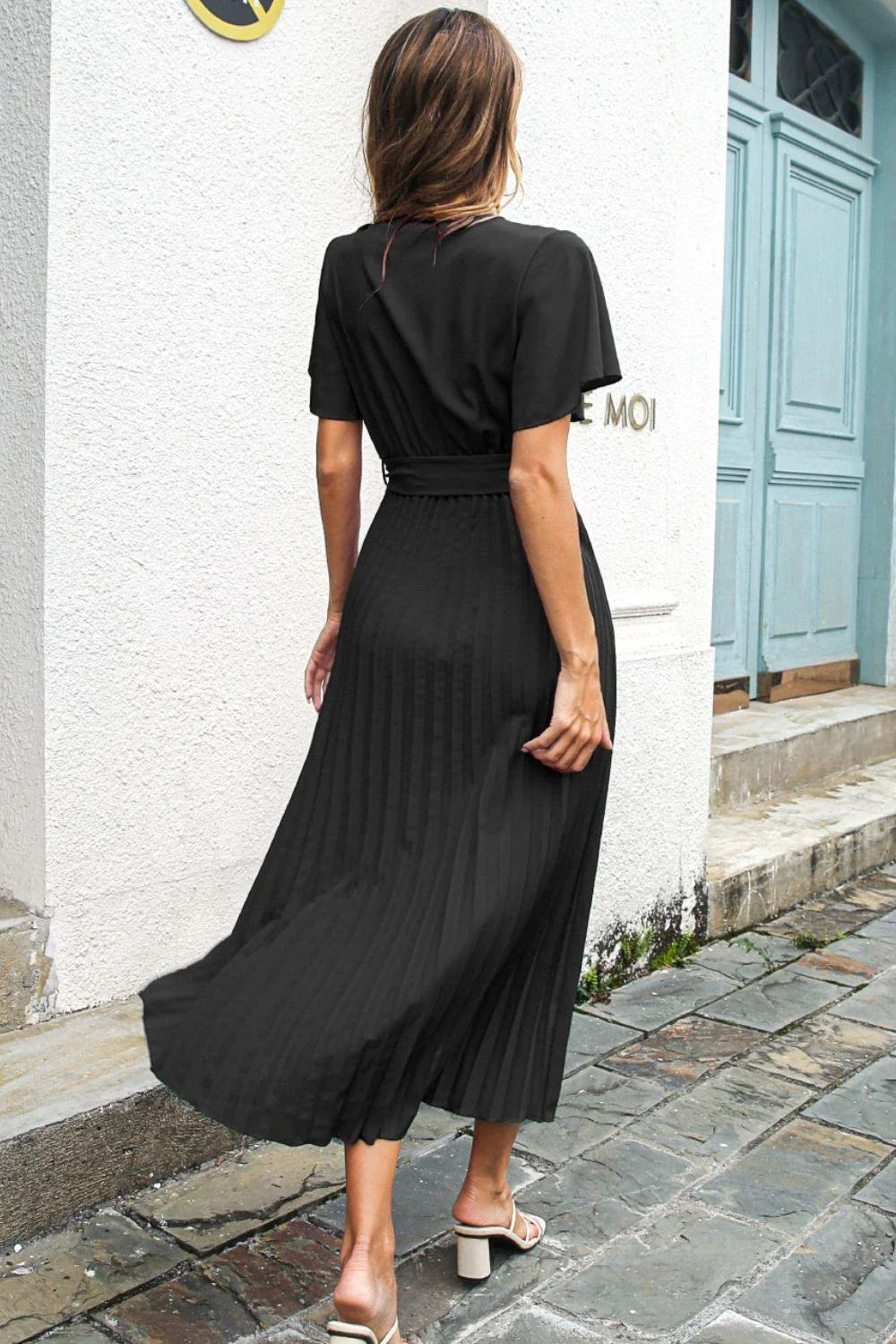 Elegant black midi dress with belted waist and flutter sleeves, perfect for any occasion