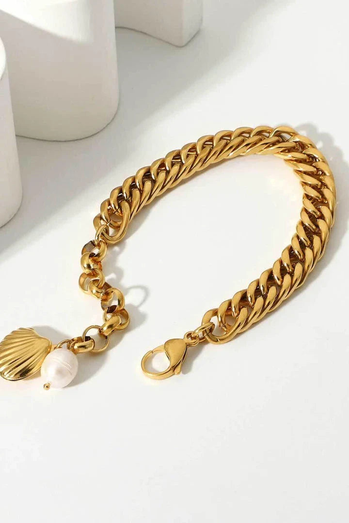 Elegant 18-carat gold-plated curb chain bracelet with a delicate pearl accent, showcasing premium British craftsmanship