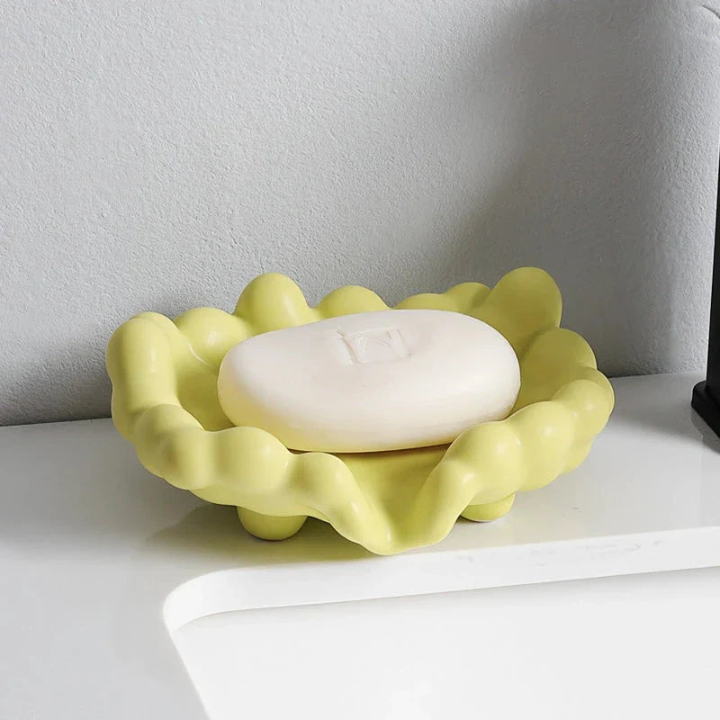 A ceramic soap dish with a whimsical cloud design, perfect for elevating your bathroom decor.