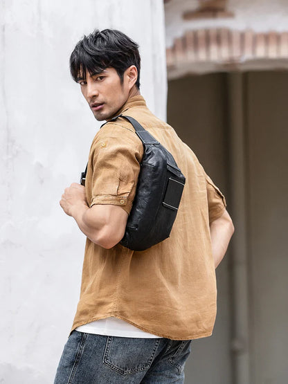 Premium cowhide messenger bag in black, featuring a spacious interior, adjustable shoulder strap, and sleek, minimalist design