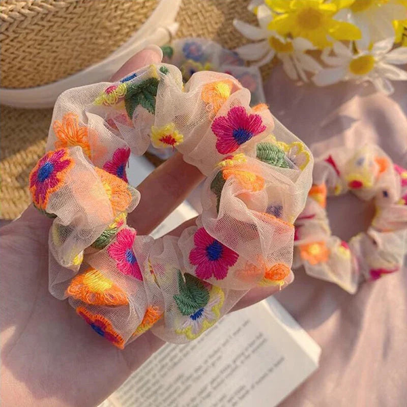 Handmade floral elastic hair bands with soft chiffon fabric and vibrant embroidered daisy patterns, perfect for enhancing everyday style in the UK.