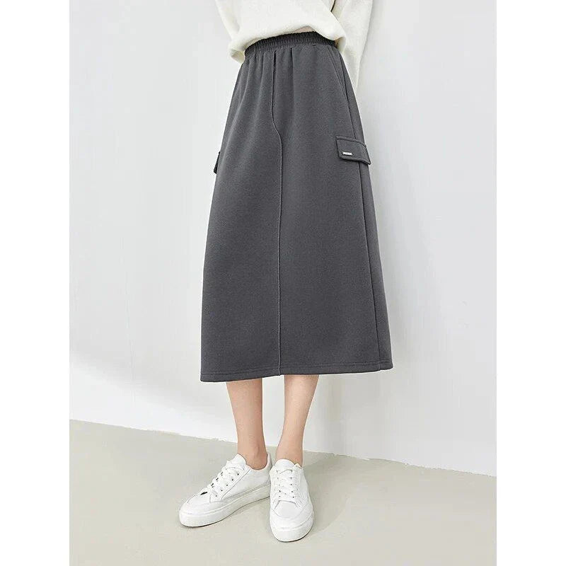 Elegant dark grey midi skirt with subtle sequin detailing, suitable for autumn and winter wear
